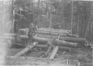 Hand loading of log truck from log yard along winter haul road, in MU5 in November 1952