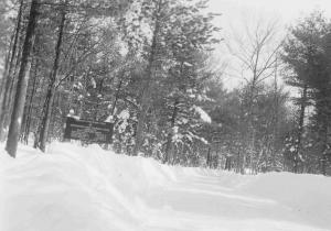 Main Penobscot Experimental Forest access road and entrance sign, winter of 1951