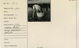 Fisheries Research Institute (FRI) demonstration. McNeil using sediment sampler. [Date estimated. Likely 1958.]