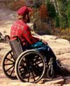 Photo of a man using a "standard" wheelchair.