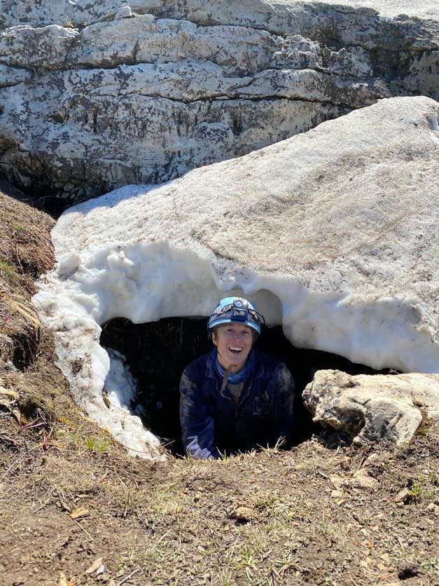 A person ridgewalking after discovering a new cave.