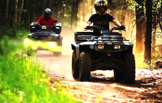 Image of two people riding ATVs.