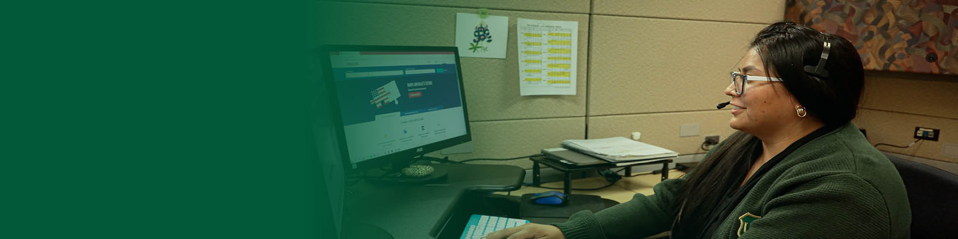 Female sits at desk with computer