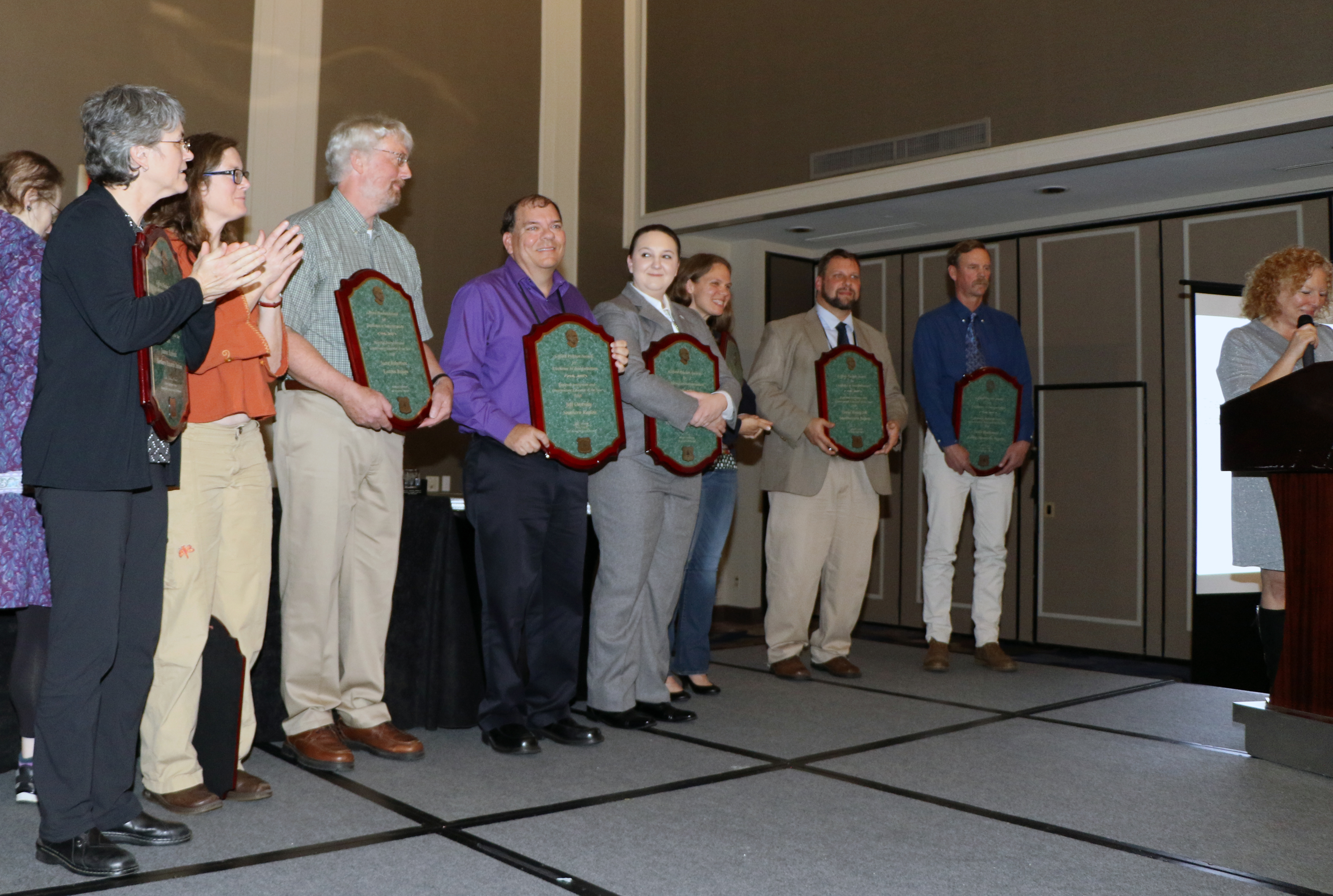 Award recipients holding their plaques.