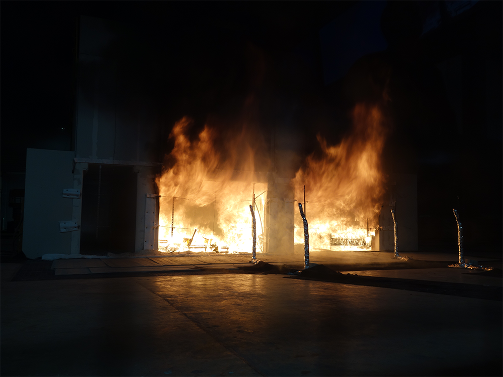 A photo of a fully engulfed cross-laminated building