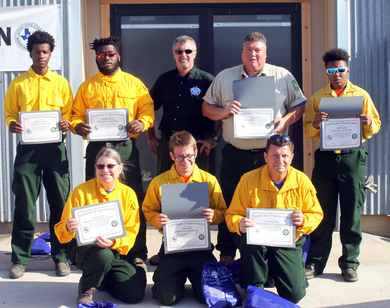 Photo: Job Corps students hold up certificates.