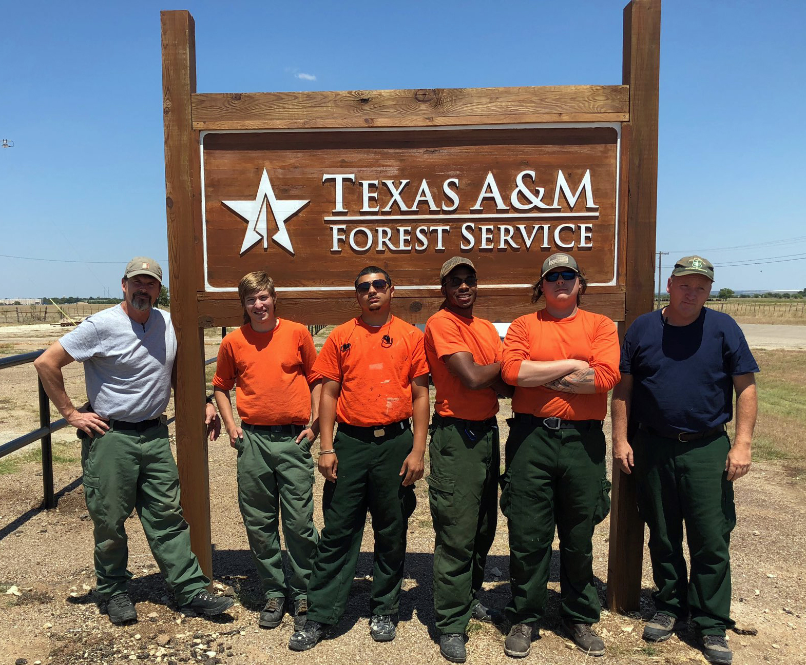 Photo: Group poses by Texas A&M Forest Service sign.