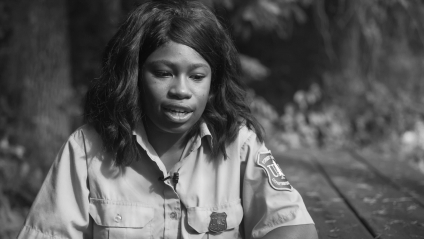 Black and white photo of a woman in Forest Service uniform