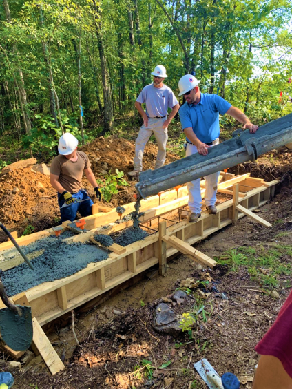 Workers pouring concrete