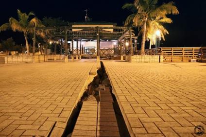 A crack on the ground, located in the middle of a cobbled plaza