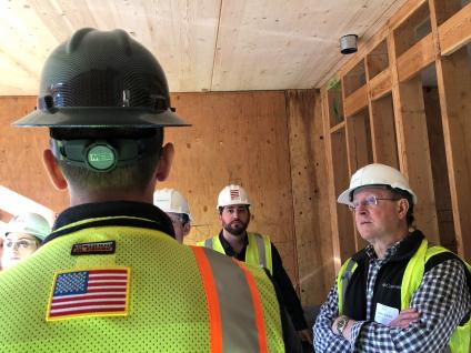 Group of men inspecting timber construction