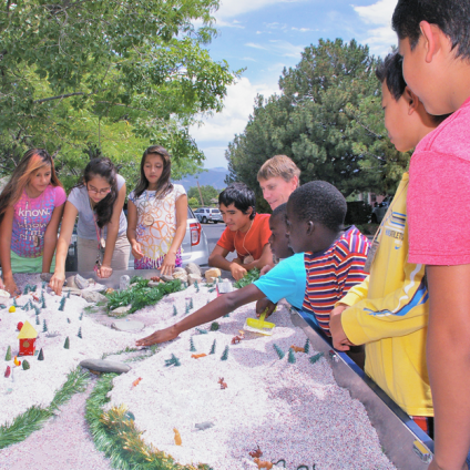 Children engage in a topographic mapping exercise as part of the More Kids in the Woods program.