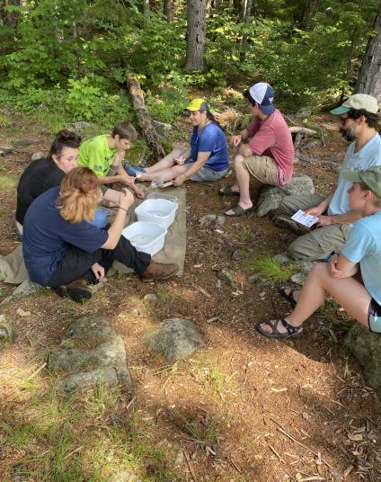 Students passing around dragonfly larvae to examine closely.