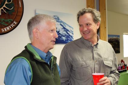 Tom Tidwell & Bill Gamble talk at an employee gathering.