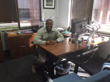 A picture of Jim Copeland siting at a desk in the Job Corps National Director’s office.