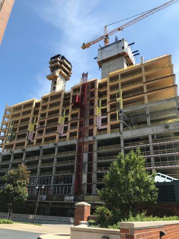 Ascent building under construction shows cross-laminated timber beams around elevator and stairwell.