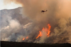 Helicopter flying over flames