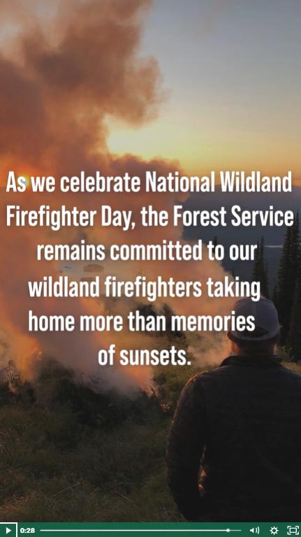 A person watching a fire burning with smoke rising, overlayed with text reading "As we celebrate National Wildland Firefighter Day, the Forest Service remains committed to our wildland firefighters taking home more than memories of sunsets."