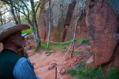 Visitors in the Coconino National Forest observing petroglyphs