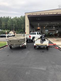 Two light aluminum boats, next to each other.