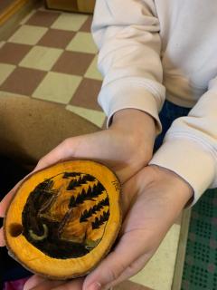 A picture of person holding a traditional ornament.