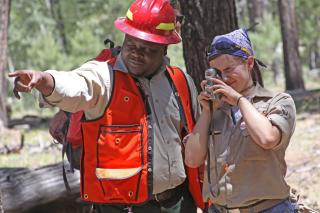 Forest Service employee working with volunteer. Forest Service photo.