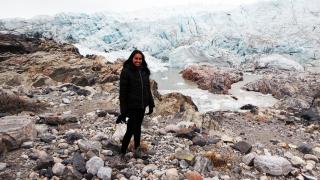 Woman standing amidst a thawed glacier