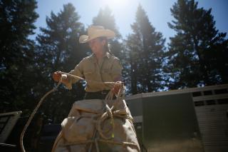 Katy Bartzokis tightens up a parcel that she will soon take into the Trinity Alps Wilderness to resupply a back country trails crew.