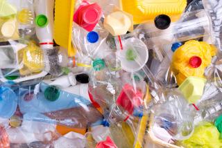 Transparent plastic bag full of variously colored containers
