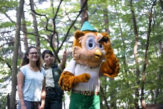 Woodsy Owl and two Forest Service employees