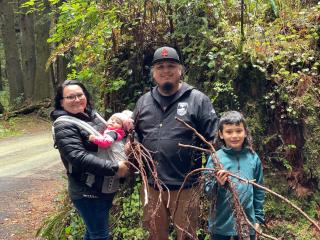 Beau Goodwin, his wife Stephanie Goodwin, son Carter Goodwin, baby girl Amelia Goodwin gather spruce roots. 