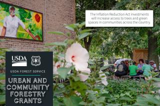 USDA Forest Service, Urban and Community Forestry Grants graphic showing a group of six people sitting at a picknic table under some trees, next to a brick building. Subtext reads "The Inflation Reduction Act investments will increase access to trees and green spaces in communities across the country."
