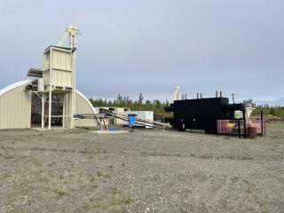 A sawmill operation in Alaska produces compressed logs from wood waste.