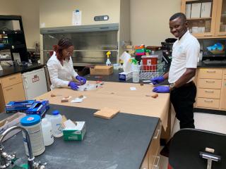 A man and a woman work together in an experiment at a lab table