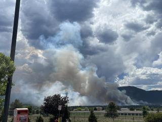 Smoke is rising over a city landscape