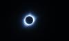 Image shows the solar corona around the moon surrounded by black during the 2017 solar eclipse.