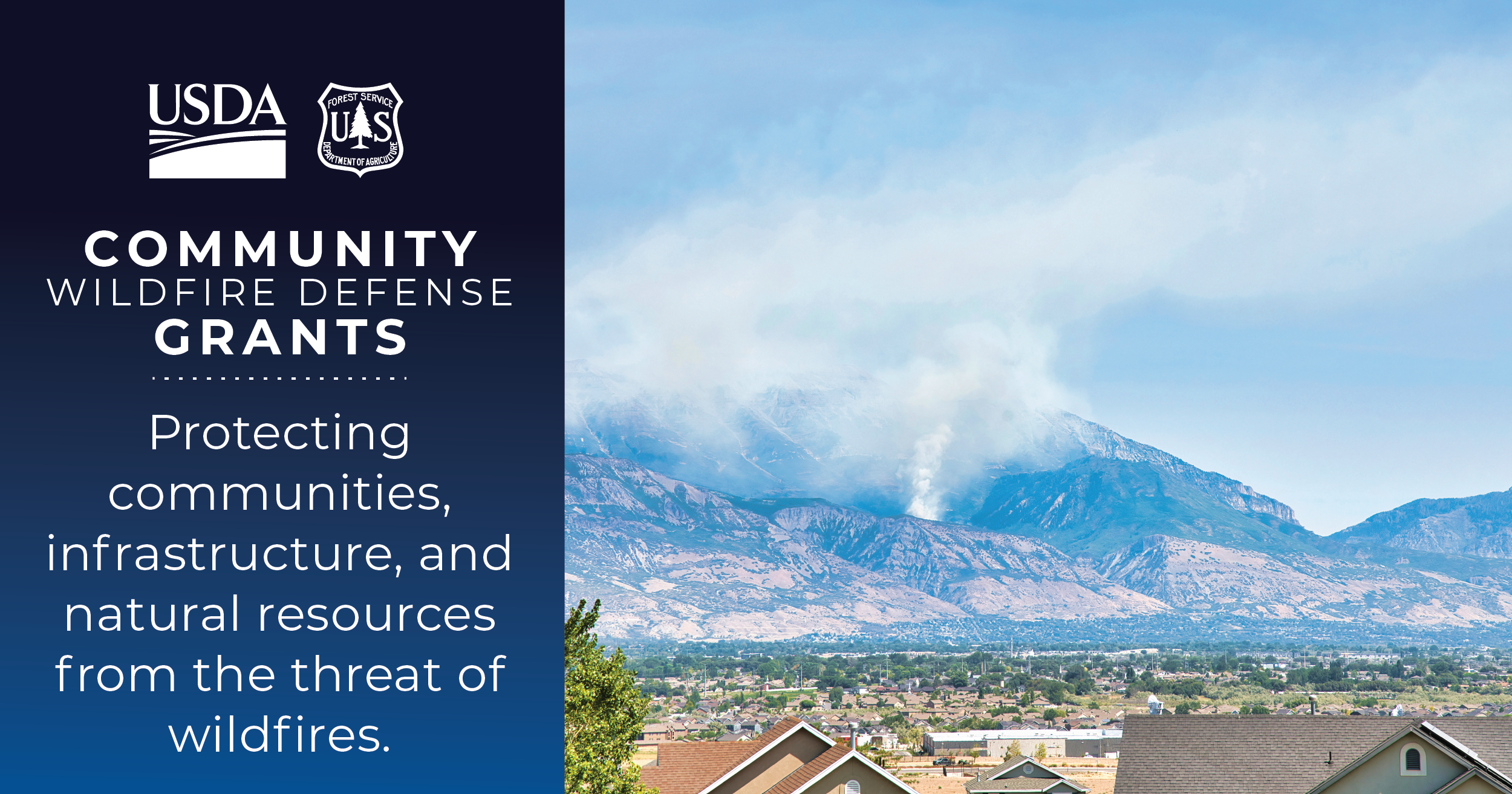 A wildfire burning in the mountains behind a community