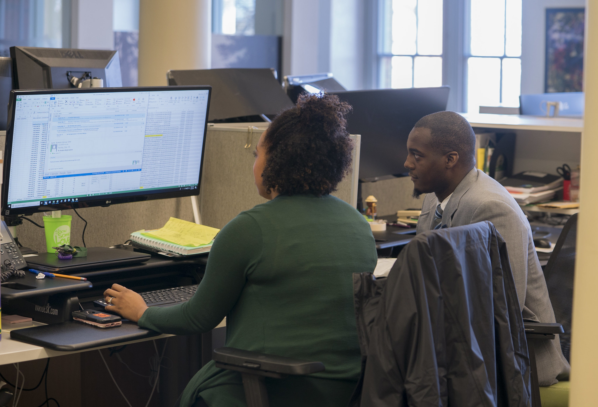 Two people using a computer.