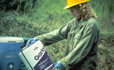 Worker reading label prior to field work