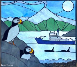 A stained glass image of puffins, whales and a ship.