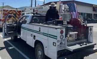 White truck with a Man in a Bear Suit on top of it