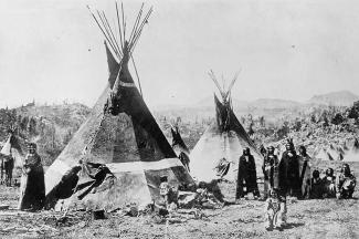 A historic photo of Native Americans with tipis