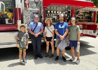 Family poses in front of San Bernardino County Fire Engine