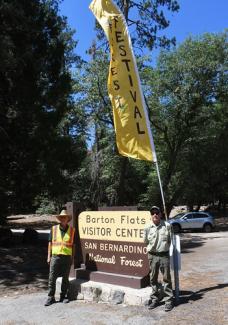Volunteers stand in front ot Bart Flats Visitor Center sign