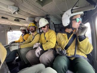 Four firefighters in a helicopter