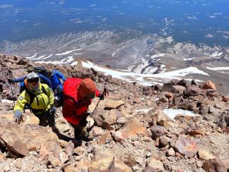 Three climbers going up Mount Shasta