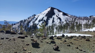 Exposed and loose rocky peak blanketed in snow