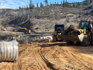 heavy equipment makes repairs to a road