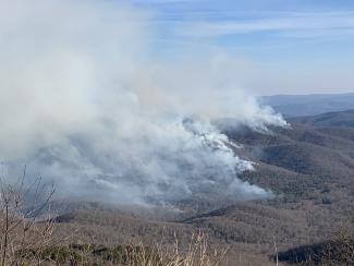 plume of smoke on top of mountain