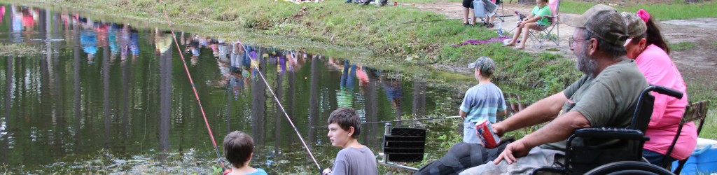 people on lake bank fishing
